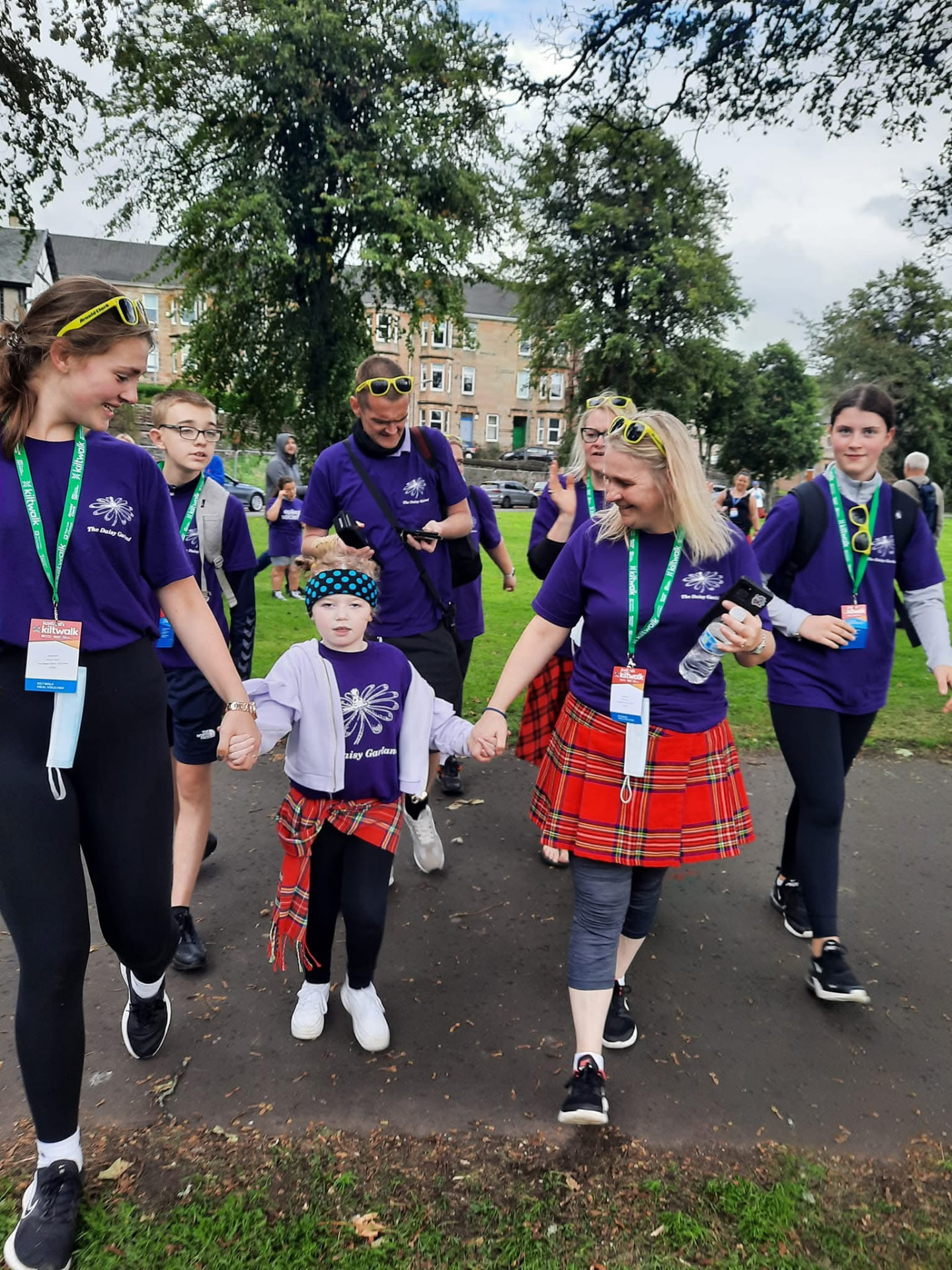 Olivia walking the Kiltwalk hand in hand with family